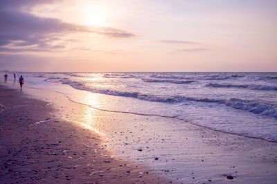 Scenic view of beach against sky during sunset