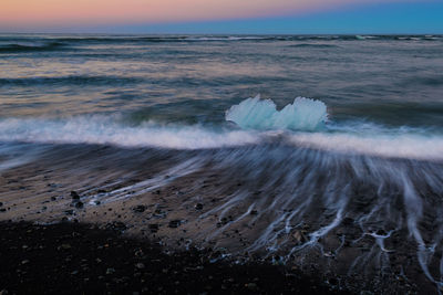 Iceberg on beach at jokulsarlon glacial lagoon