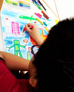 Low angle view of mother and daughter against multi colored book