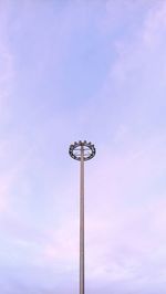 Low angle view of illuminated street light against sky