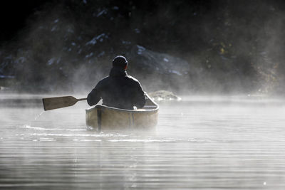 Rear view of man in sea