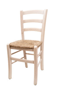 Empty chair and table against white background