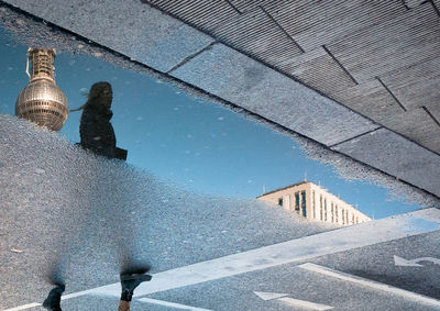 Reflection of buildings in puddle