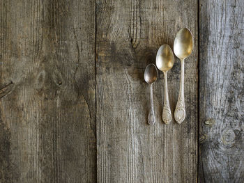 Directly above shot of abandoned spoons on old table