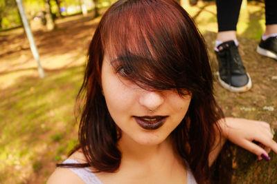 Close-up portrait of young woman in park