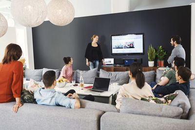 Mature businesswoman giving presentation to colleagues in office lobby