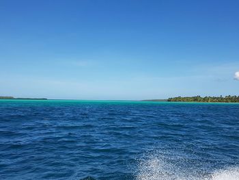 Scenic view of calm sea against clear sky