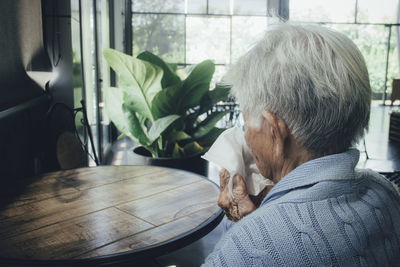 Rear view of man on table