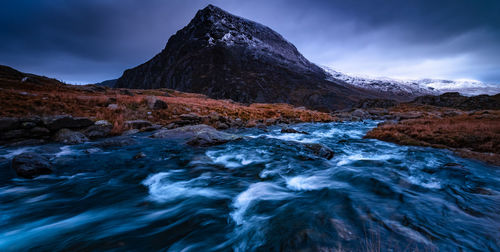 Long exposure image of river against sky