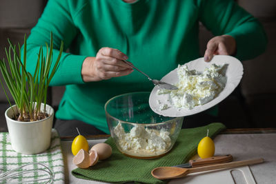 Midsection of man preparing food on table