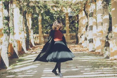 Rear view of woman standing in park