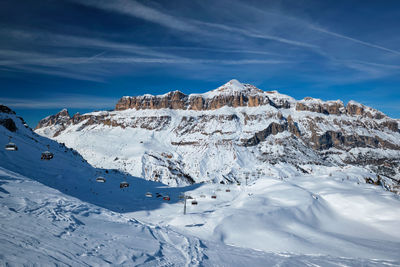 Scenic view of snowcapped mountains against blue sky