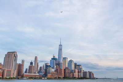 Cityscape against cloudy sky