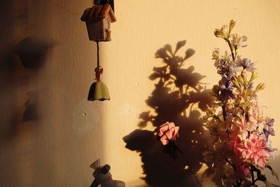 Shadow of flowers hanging on wall