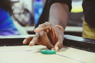 Midsection of man playing carom