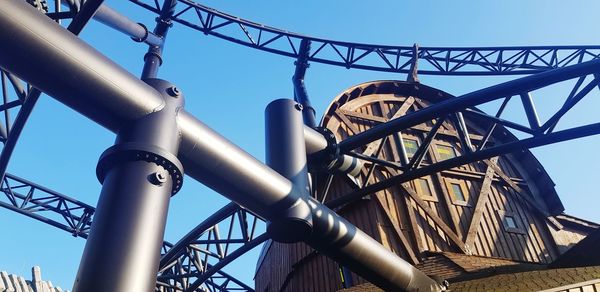 Low angle view of bridge against clear blue sky