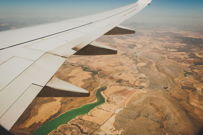 Cropped image of airplane flying over landscape