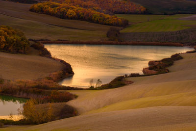 Scenic view of river by landscape against sky