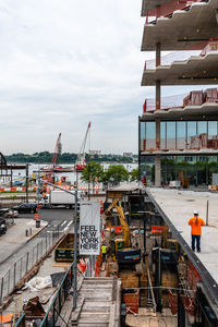 Construction site at harbor against sky