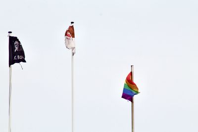 Low angle view of flag flags against clear sky