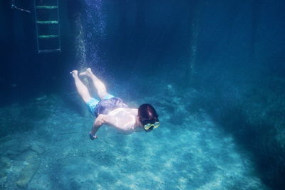 High angle view of man swimming in sea