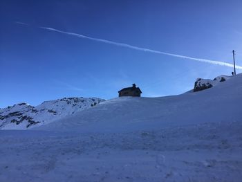 Scenic view of snowcapped mountain against blue sky