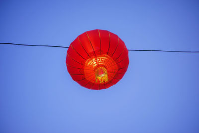 Low angle view of chinese lantern against clear blue sky