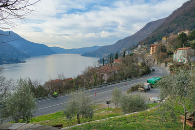 Panoramic view of city by mountains against sky