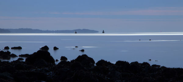 Scenic view of sea against sky at dusk
