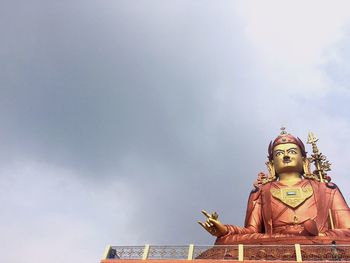 Low angle view of padmasambhava statue against sky