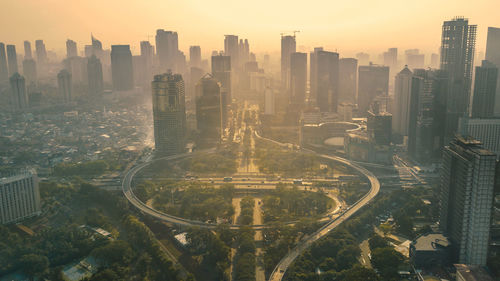 High angle view of buildings in city against sky during sunset