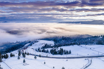 Scenic view of snow covered landscape against sky