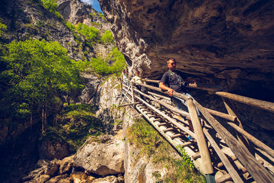 High angle view of man climbing on rock