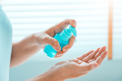 Close-up of woman hand holding bottle