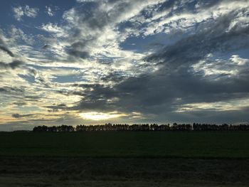 Scenic view of field against sky during sunset
