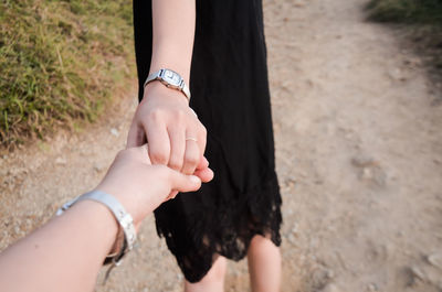 Cropped hand of boyfriend holding girlfriend