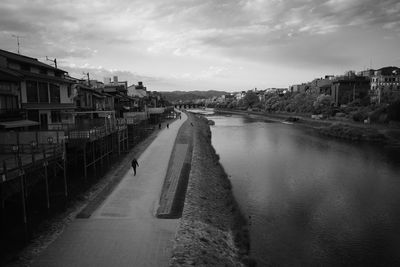 River amidst buildings against sky