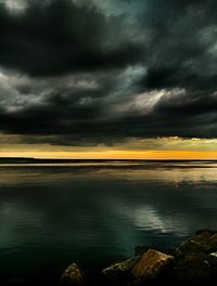 Scenic view of sea against dramatic sky