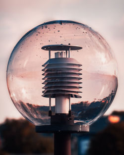 Close-up of light bulb against sky