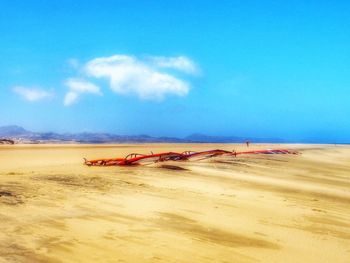 Scenic view of beach against blue sky