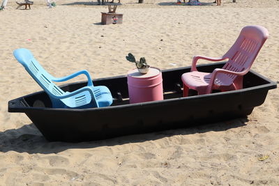 High angle view of empty chairs at beach