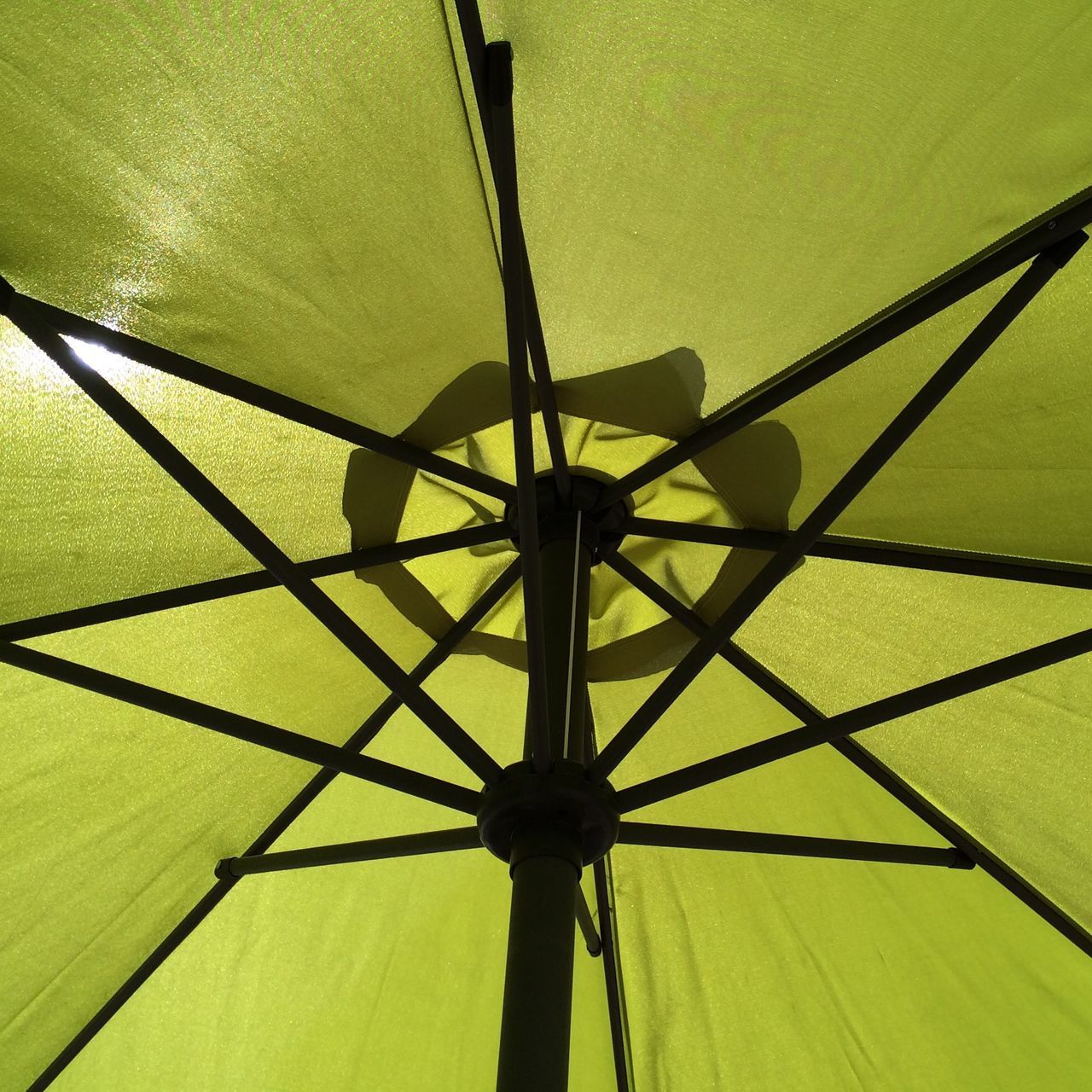 low angle view, pattern, metal, yellow, indoors, ceiling, protection, built structure, close-up, metallic, umbrella, design, geometric shape, directly below, no people, day, sunlight, architecture, backgrounds, full frame