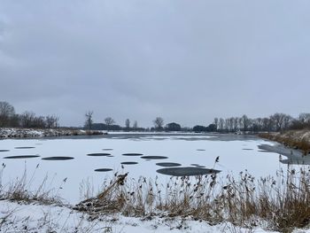 Scenic view of frozen lake against sky