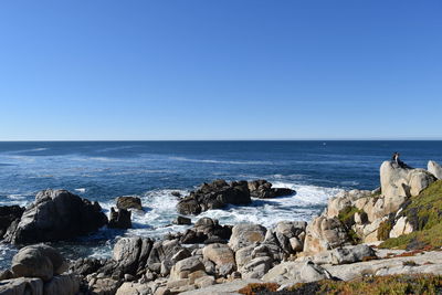 Scenic view of sea against clear blue sky