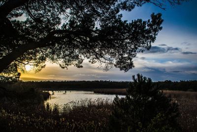 Scenic view of lake against sky during sunset