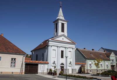 View of buildings against clear blue sky