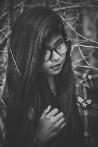 Young woman with long hair looking away