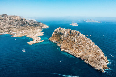 High angle view of rocks by sea against sky