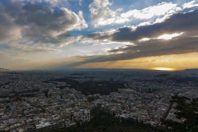 Aerial view of cityscape against sky during sunset