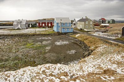 Flatey, iceland, may 5, 2022, view across a tiny bay towards the village with its colorful houses